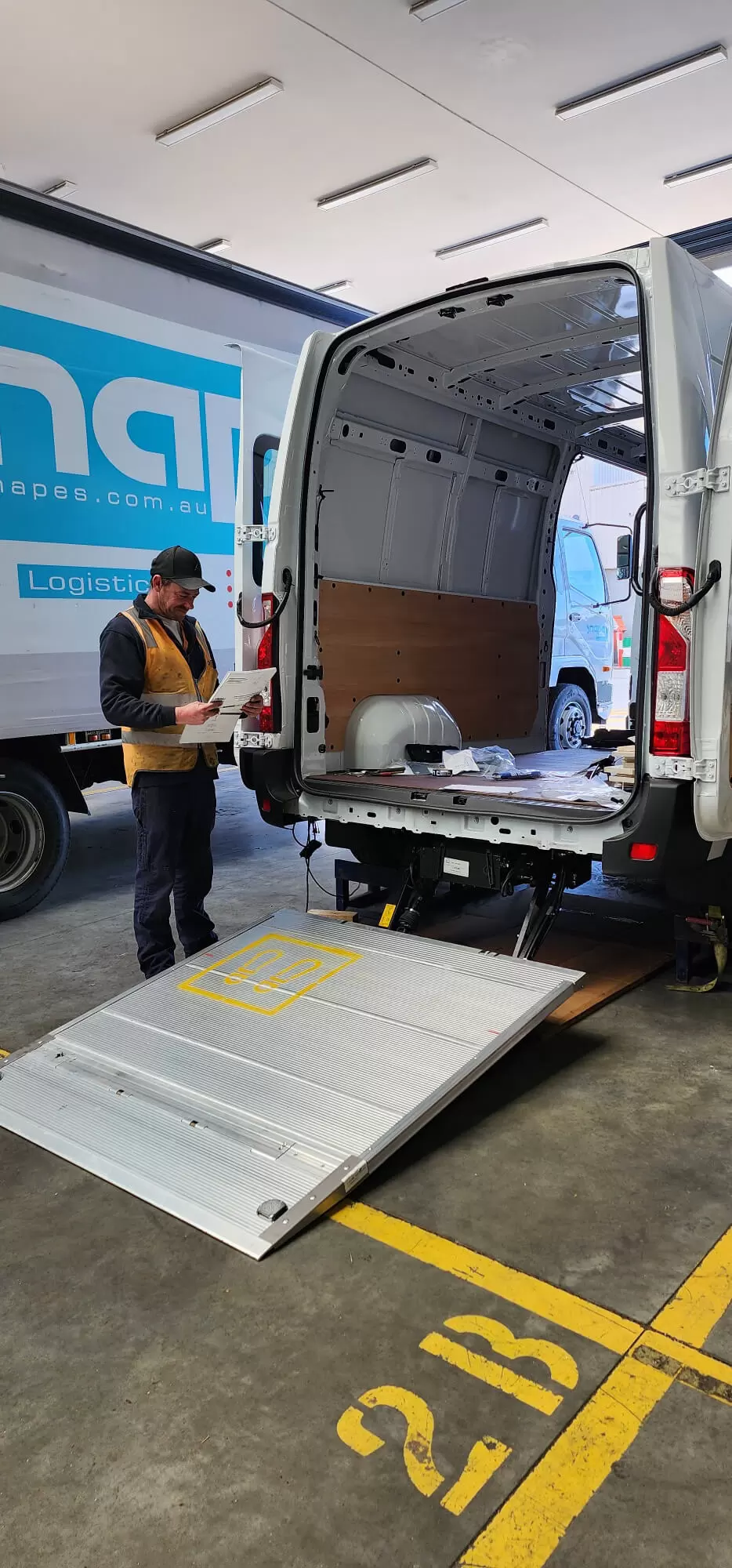 worker inspecting open delivery van