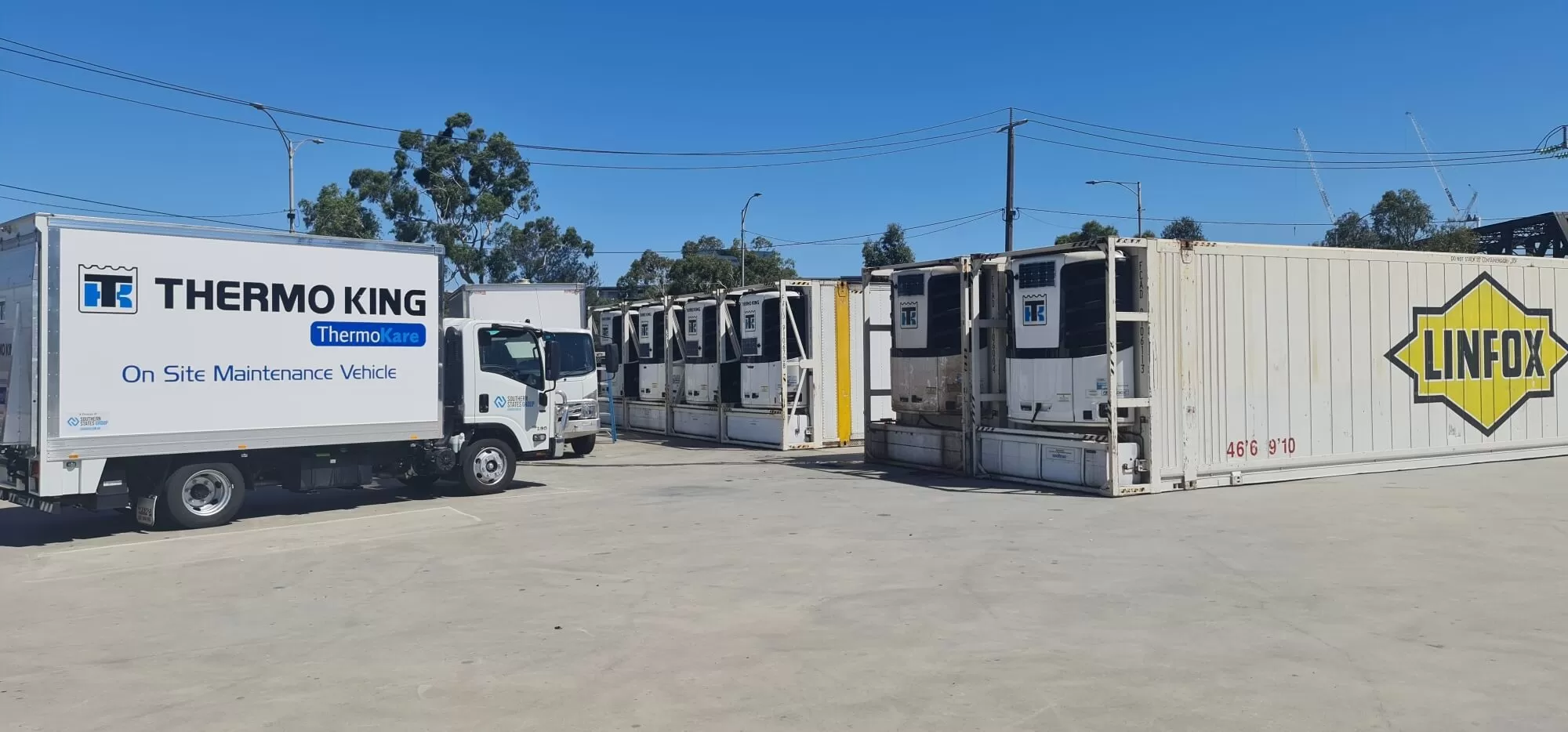 thermo king vehicle and containers in a parking space