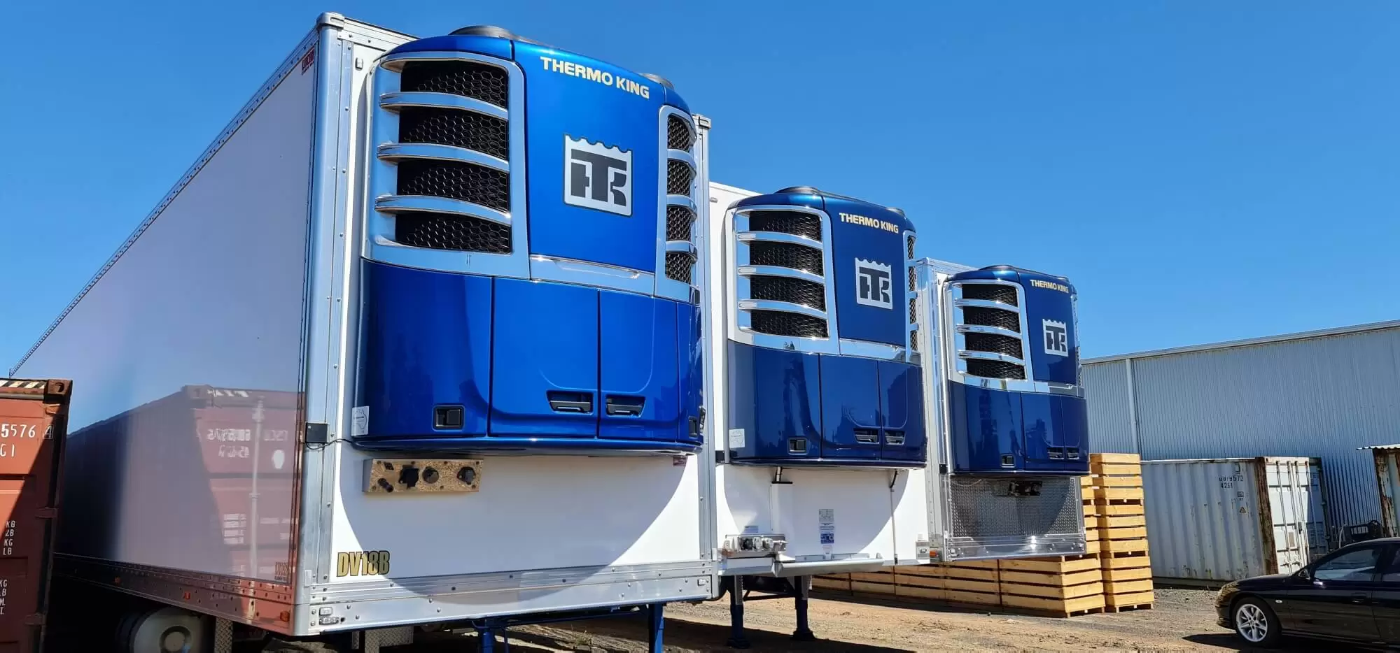 three thermo king refrigerated units on trailers