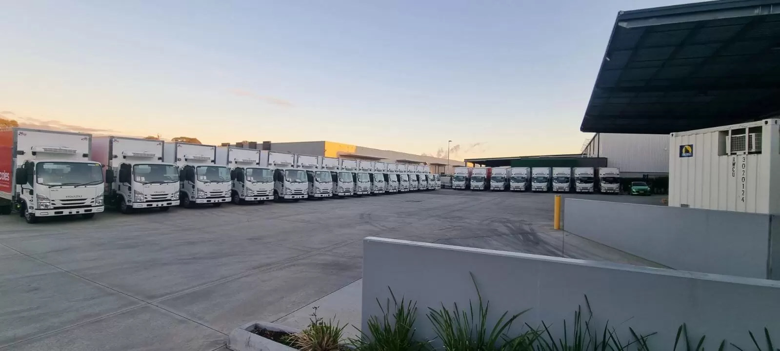 delivery trucks parked in a wide space