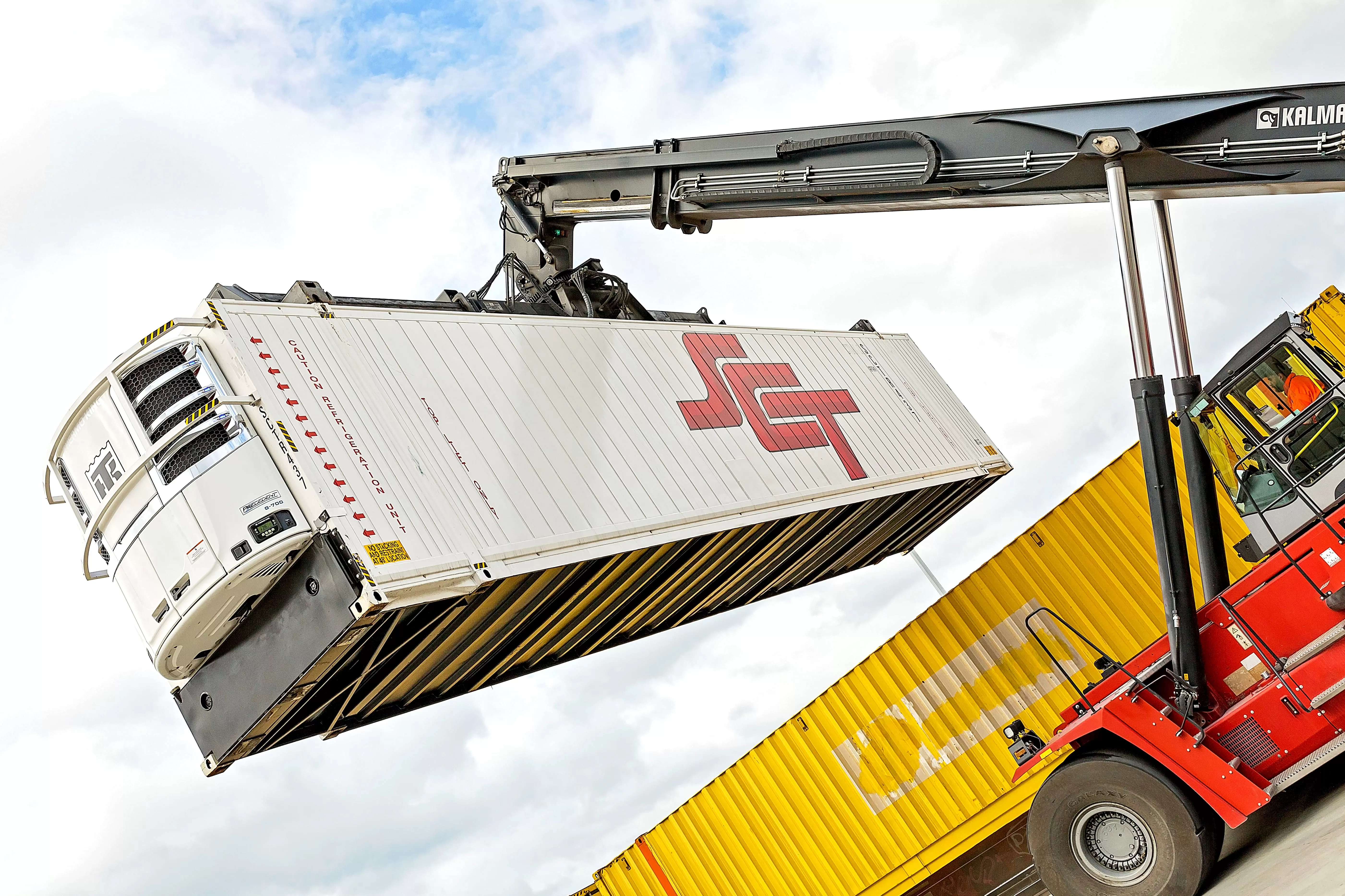 crane lifting refrigerated SCT container